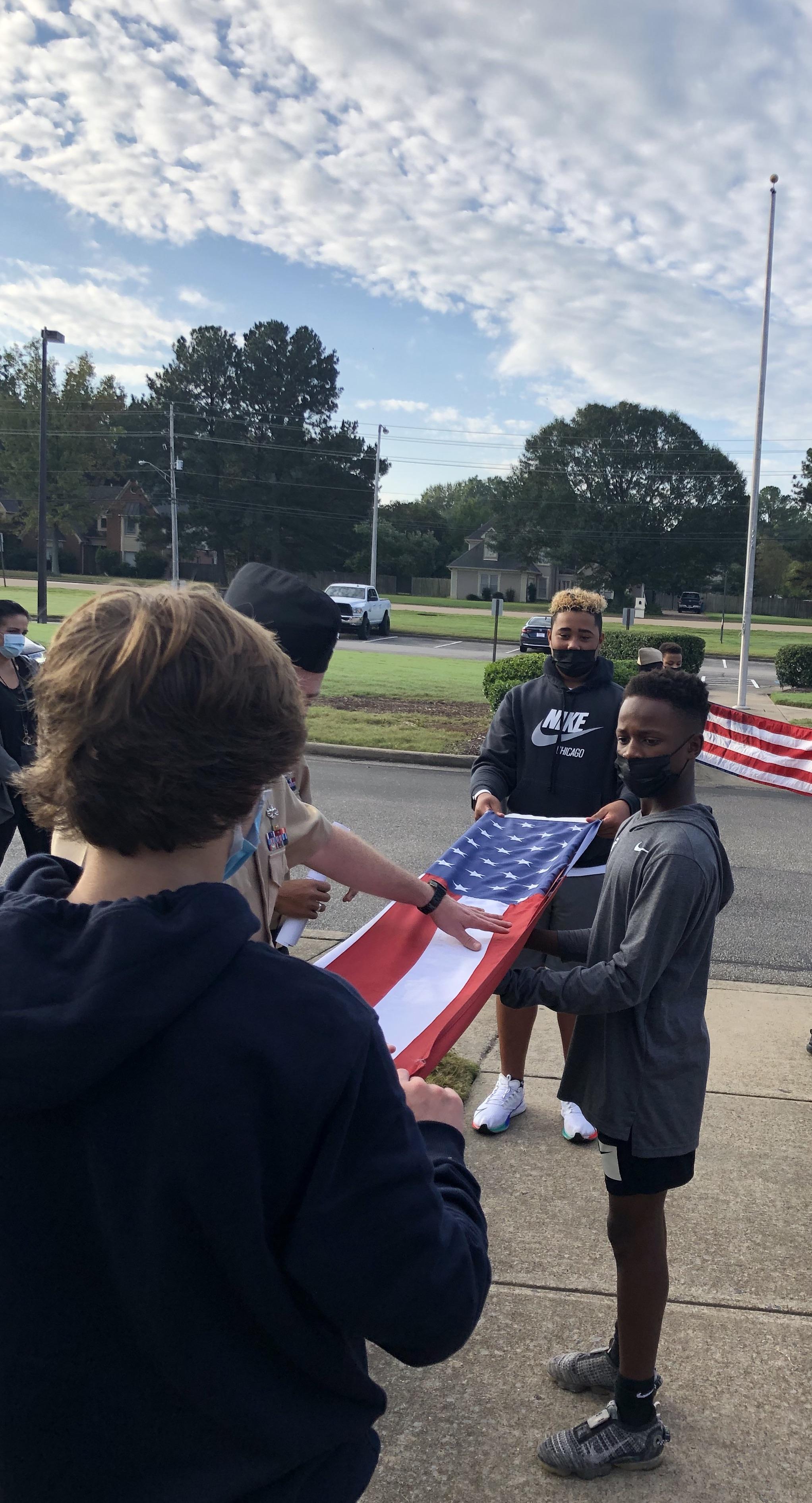 students walk with flag